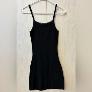 Melville Belle Lace Dress, a black ribbed cotton mini dress with a lace neckline